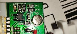 Close-up of a circuit board with a microphone and SMD components visible.