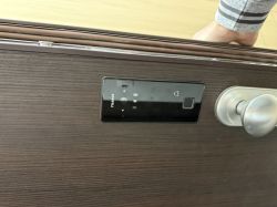 Electronic Lock on Wooden Door Electronic door lock with handle on wooden door.