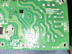 Close-up of PCB with SMD components and traces Close-up of a green circuit board with visible traces and electronic components.