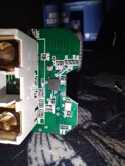 Printed circuit board with electronic components and part of an electrical socket.