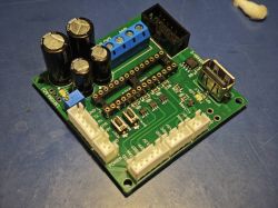 Soldered PCB for Raspberry Pi power supply testing Soldered electronic PCB with components and connectors on blue surface