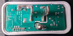 Close-up of a smart plug circuit board with visible traces and electronic components.