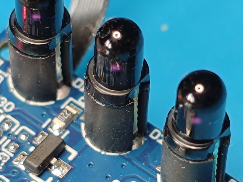 Close-up of infrared sensors on a blue printed circuit board