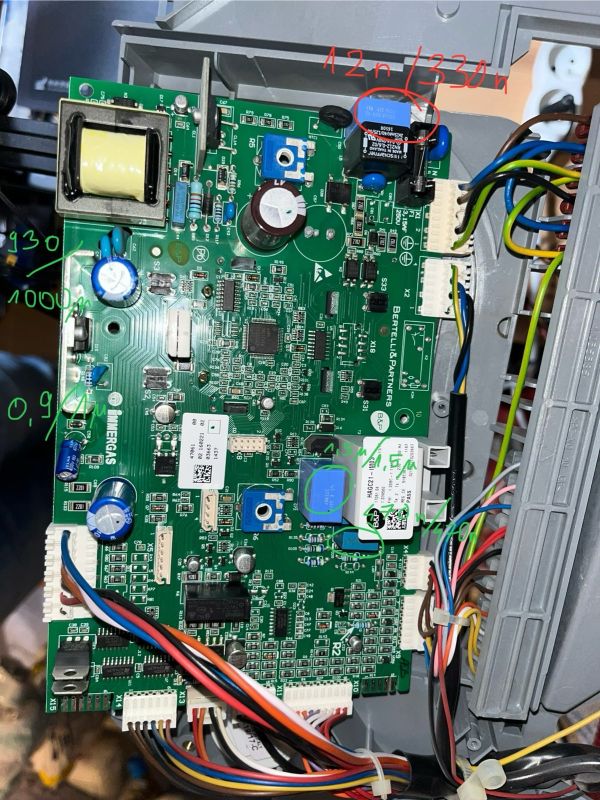 Close-up view of Immergas boiler mainboard with highlighted and annotated capacitors and other electronic components.
