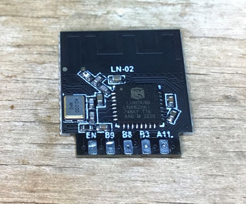 WiFi Module with LN882H Chip WiFi module with Lightning LN882H chip on a wooden surface.