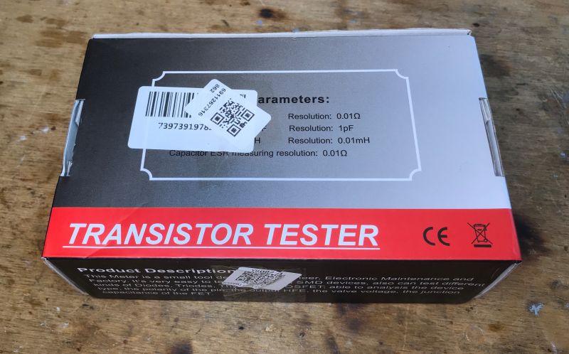 Box of BSIDE ESR02 Pro Transistor Tester Box of the BSIDE ESR02 Pro transistor tester on a wooden table.