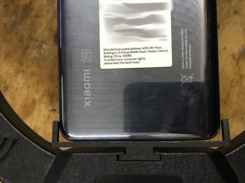 Xiaomi smartphone in a black 3D-printed holder mounted to a ring light