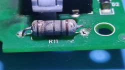 Image of a damaged resistor R11 on a circuit board.