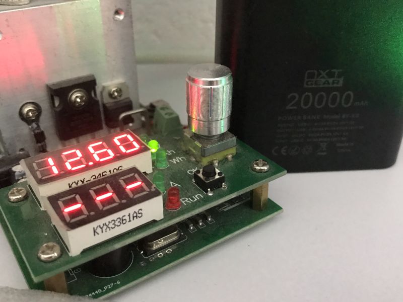 Voltage tester showing 12.6 V next to NXT Gear 20000 mAh power bank