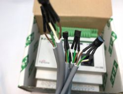 Several DS18B20 digital temperature sensors on wires, close-up view with a box in the background.