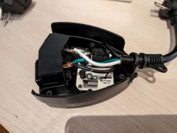 Interior of an electric device with visible wiring and a chip.
