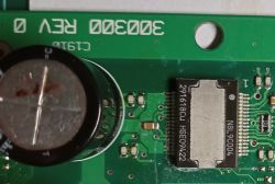 Close-up of a circuit board with a capacitor and an integrated circuit.