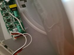 Close-up of internal wiring and circuit board in a hanging lamp.