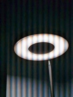 Round Floor Lamp in a Dark Room Round floor lamp illuminated in a dark room.