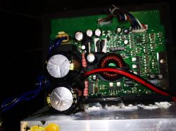 Wnętrze subwoofera Monacor Sound - 100sub z widocznymi elementami elektronicznymi i czarnym nalotem.