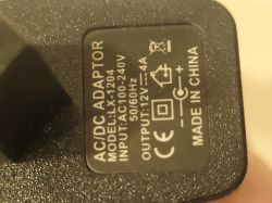 Close-up of AC/DC adapter label.