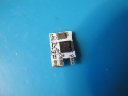 Small PCB with Chip Small PCB with electronic components on a blue background.