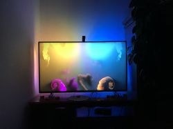 TV with colorful LED backlight Govee mounted behind the screen