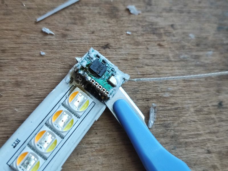 LED Module with Electronic Controller LED board with connected electronic module and tool on wooden surface.
