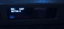 OLED display showing ADC 4227 and BUTTON 0.