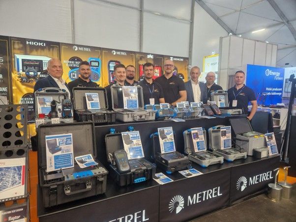 Grupa osób przy stoisku firmy Metrel na targach Energetab 2025