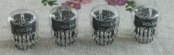 Four DOLAM LC-513 nixie tubes arranged side by side on a fabric background.