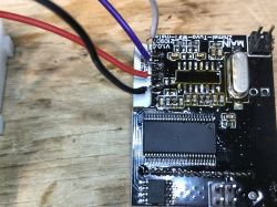 PCB board with visible electronic components and connected wires.