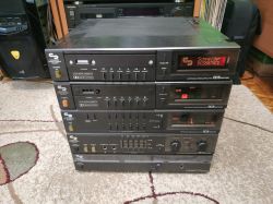 1980s Schneider Hi-Fi stack with multiple black audio components on a carpet