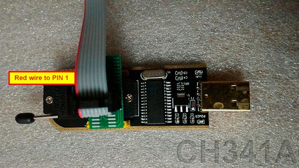 CH341A adapter with IDC ribbon cable connected, red wire marks pin 1