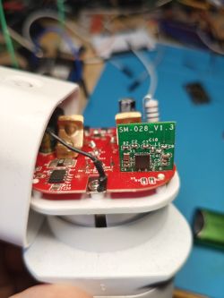 Close-up of red PCB with green SM-028_V1.3 board and various mounted components.