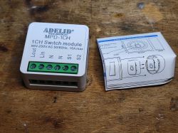 Adelid MPD-1CH switch module with wiring diagram insert on a wooden surface