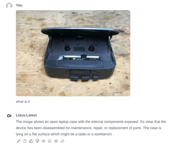 Open Electronic Device on a Table Image of an open electronic device lying on a wooden table.