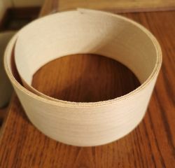 Rolled thick furniture veneer on a wooden surface