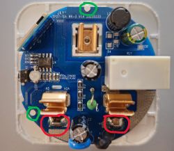 Interior of electronic device showing PCB with marked components and burn marks