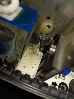 Fragment of an electronic circuit with visible capacitor and connectors.