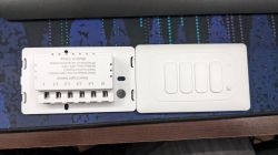 Wi-Fi Wall Switch with Four Buttons Wall switch with four buttons and visible electrical connections.
