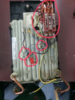 Interior of a water heater showing electrical components and wire connections.