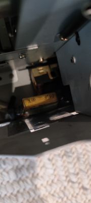 Widok wnętrza magnetofonu z kondensatorem zamontowanym na wyłączniku sieciowym.