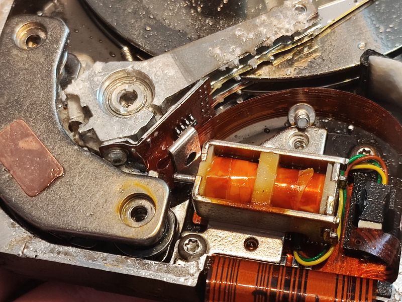 Damaged Hard Drive with Moisture Traces Interior of a damaged hard drive with visible moisture.