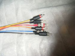Multicolored cables with RCA connectors on a gray background.
