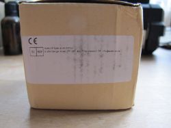 Box with Apex CE Specialists GmbH Label A cardboard box with a label containing details of Apex CE Specialists GmbH.