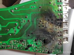 Damaged circuit board with visible burn marks.