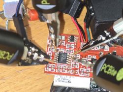 Close-up of a PCB connected with probes.