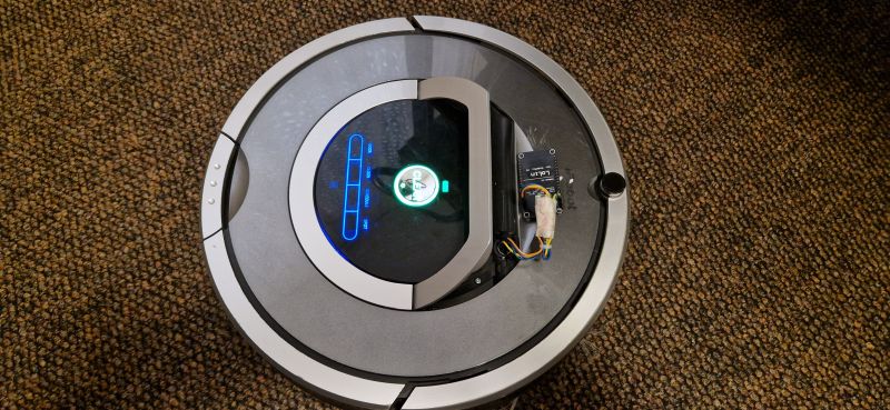 Roomba 780 with Attached WiFi Module iRobot Roomba 780 vacuum cleaner with an attached WiFi module on top.