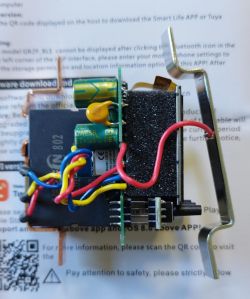 View of the inside of an electronic device with visible wires and components.