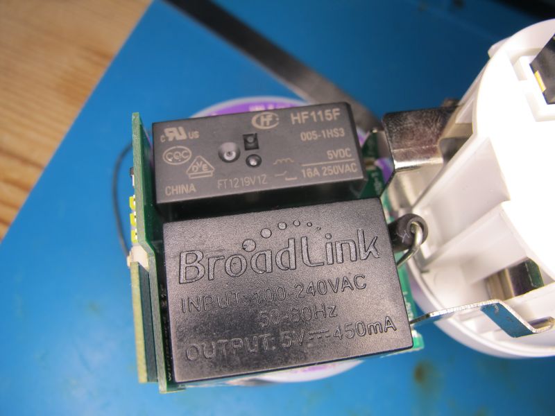 Close-up of a BroadLink module with HF115F relay inside a smart socket housing