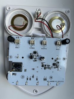 Interior of a solar-powered siren with visible circuit board and speakers.
