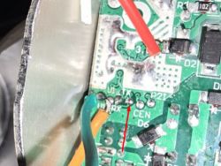 Close-up of a PCB with connected wires and pin labels, including U1_TX indicated by an arrow.