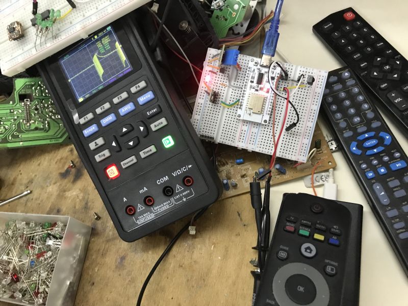 IR testing with BK7238 on breadboard and oscilloscope Digital oscilloscope with waveform and breadboard setup testing BK7238 IR circuit