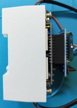 Opened View of Device with Electronic Components Side view of an opened electronic device with visible components on PCB boards.